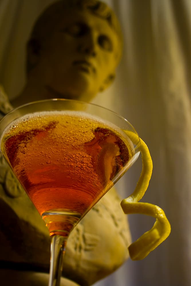 ashley_wilkes_cocktail_squoosh The Ashley Wilkes cocktail in a martini glass in front of a bust of Augustus Caesar